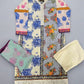 Floral patterned garment with lace trim on a wooden surface