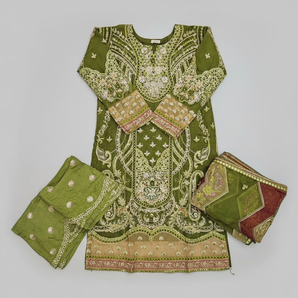 Green embroidered traditional outfit with matching dupatta on a wooden floor