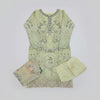 Light green embroidered traditional outfit on a wooden floor