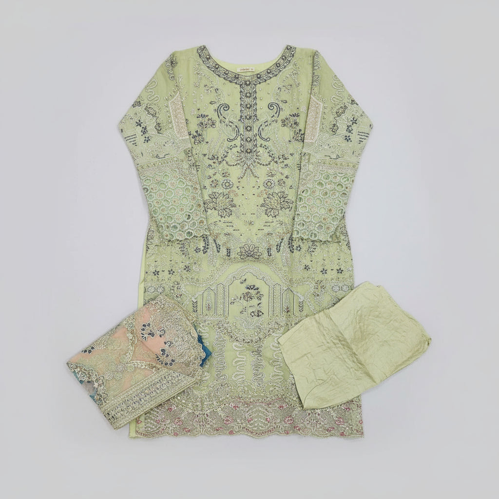 Light green embroidered traditional outfit on a wooden floor